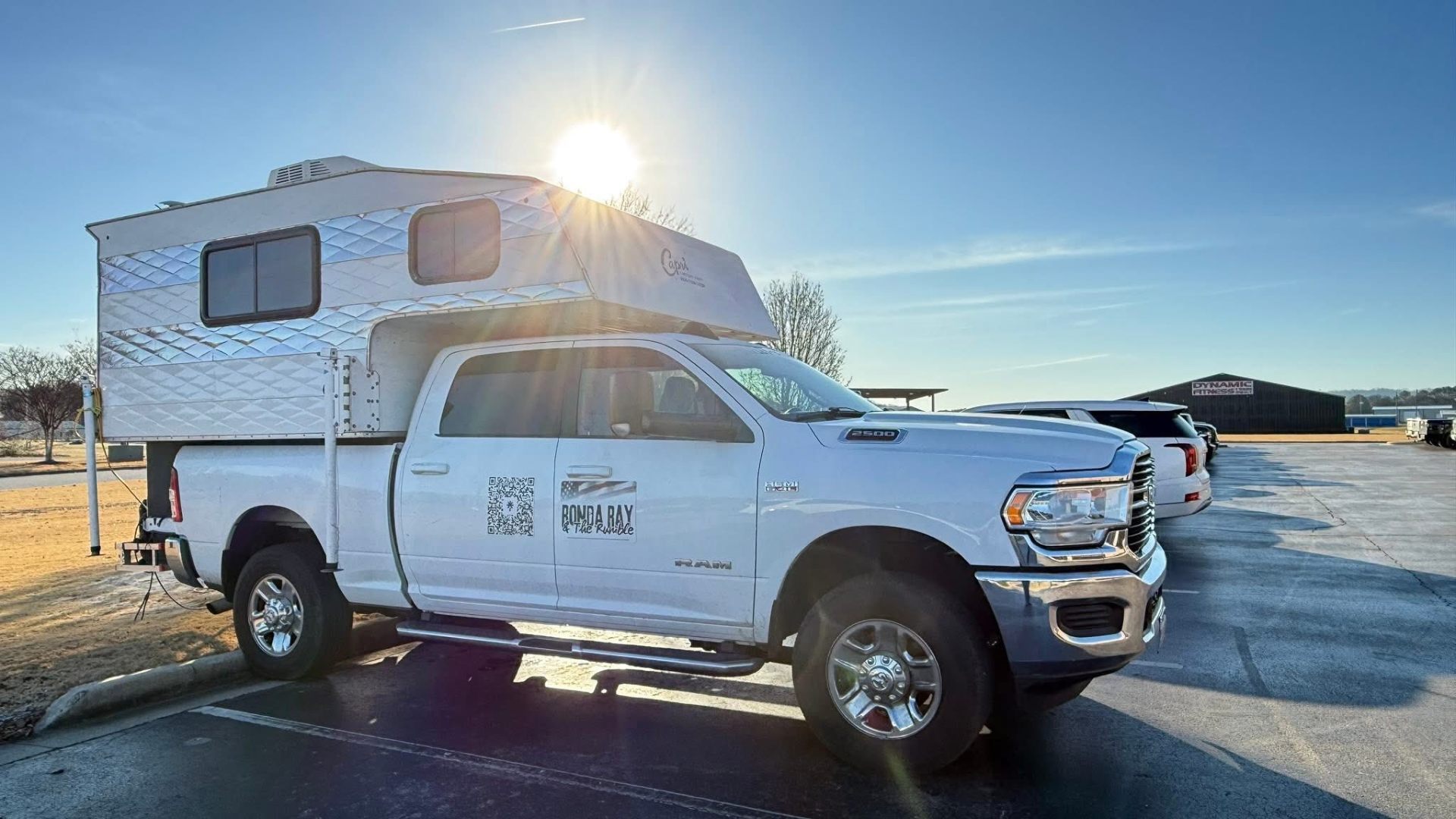 Ronda Ray & The Rumble tour truck with Capri camper at sunrise